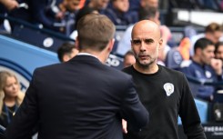 Manchester City manager Pep Guardiola (right) has apologised to Steven Gerrard (left) 