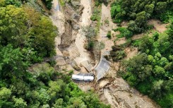 A New Zealand Defence Force photo shows a truck stranded on a road covered with debris near Wairoa on the east coast of New Zealand's North Island