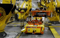 A robot lifts a battery for installation in a Ford F-150 Lightning in Dearborn, Michigan in September 2022 