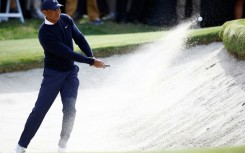 Tiger Woods blasts out of a bunker on the way to a two-under par opening round at the Genesis Invitational, his first US PGA Tour event since July