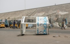 A traffic control booth lies on its side after angry protesters took to the streets of Lagos