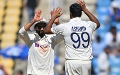 India's Ravichandran Ashwin (right) celebrates an Australian wicket with Ravindra Jadeja