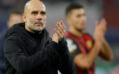 'Nine strikers': Manchester City coach Pep Guardiola applauds the fans in Leipzig