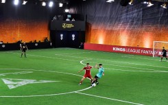 Players of Jijantes FC (L) and PIO FC teams vie for a ball on a 2 vs 2 period at the Cupra Arena stadium in Barcelona