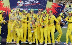 Australia's captain Meg Lanning (C) holds the trophy with her teammates after they won the T20 women's World Cup 
