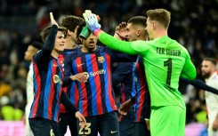 Barcelona's players celebrate at the end of the Copa del Rey first leg victory over Real Madrid