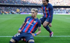 Barcelona's Brazilian forward Raphinha (L) celebrates scoring his team's opener against Valencia