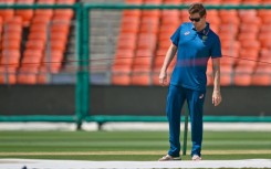 Australia's captain Steve Smith inspects the pitch at the Narendra Modi Stadium in Ahmedabad