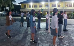 High school students gather for roll call in the Indonesian city of Kupang, where classes start at 5:30 am.