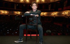 In this file photo taken on July 7, 1997, rocker Lou Reed poses on the stage of the Odeon Theatre in Paris, just before reading his poems in the show, "The music of city and time"