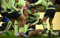 Manchester City striker Erling Haaland (C) celebrates with team-mates