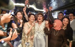 "I'm very happy... I'm proud of my daughter," said Janet Yeoh (centre) in Kuala Lumpur