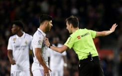 Spanish referee Ricardo De Burgos Bengoetxea (R) talks to Real Madrid's Spanish midfielder Marco Asensio after annulling his goal
