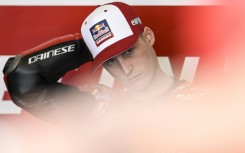 Crashed out: Pol Espargaro sits in the box prior to taking part in the second free practice session 