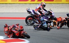 Francesco Bagnaia (left) avoids the crash that wiped out Marc Marquez (right) and Miguel Oliveira
