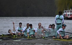 Cambridge University celebrate after their victory over Oxford University in the 168th men's boat race