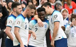 England's Bukayo Saka (2R) celebrates scoring against Ukraine