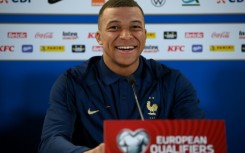 France striker Kylian Mbappe smiles during a press conference on the eve of a Euro 2024 qualifier against the Republic of Ireland in Dublin