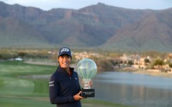 Celine Boutier of France poses with the trophy after beating Georgia Hall in a playoff to win the LPGA Drive On Championship in Arizona