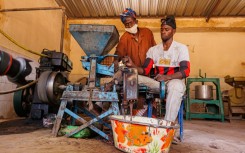Machine grinding shea nuts into a paste to produce the butter