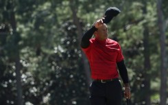 Tiger Woods tips his cap to a supportive crowd at the 18th green after completing his final round at last year's Masters, his first event after suffering severe leg injuries in a 2021 car crash