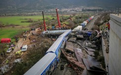 Rescue services search wrecked carriages, a day after the February 28 rail disaster