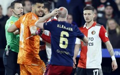 The Dutch cup semi-final was interrupted for almost half an hour when a lighter thrown from the stands hit Ajax player Davy Klaassen in the head