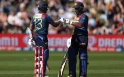Sri Lanka's Kusal Mendis (L) celebrates 50 runs with teammate Kusal Perera during the third Twenty20 cricket match between New Zealand and Sri Lanka 