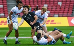 New Zealand's Leroy Carter (centre) during his side's 47-0 trouncing of Hong Kong, one of three opening-day victories for the All Blacks Sevens