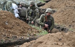 Ukrainian troops in a trench near near the battleground city of Bakhmut on April 8, 2023