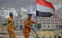 Fighters loyal to Yemen's Huthi rebels stand guard in the capital Sanaa during a rally on March 26, 2023