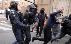 Demonstrators burn an effigy of Macron during a pensions protest in Paris on April 6