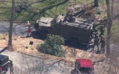 A screen grab shows law enforcement taking into custody Jack Teixeira -- suspected of being behind a major leak of classified US documents