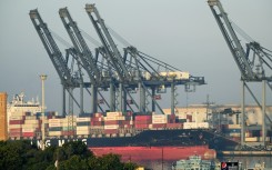 Shipping containers are seen stacked on a ship at port in Karachi on April 6, 2023. Pakistan has only enough forex reserves to pay for a month of imports