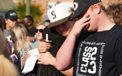 Mourners attend a vigil outside a church in Dadeville, Alabama on April 16, 2023, the day after a mass shooting at a teen's birthday party left four people dead and 28 others injured