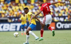 Al Ahly star Mahmoud Kahraba (R) fights for the ball during a 2023 CAF Champions League group match against  Mamelodi Sundowns of South Africa in Pretoria.