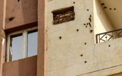 Bullet holes riddle the facade of a building in Khartoum 