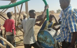 Sudanese collect water amid shortages caused by fighting
