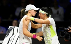 Iga Swiatek (L) consoles Ons Jabeur after the Tunisian is forced to retire in their Stuttgart semi-final