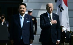 US President Joe Biden and South Korean President Yoon Suk Yeol listen to the national anthems at the White House