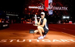 Poland's Iga Swiatek poses with the trophy after defeating Aryna Sabalenka in Stuttgart
