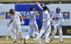 Sri Lanka's Ramesh Mendis (2L) celebrates with teammates after taking the wicket of Ireland's Andrew McBrine