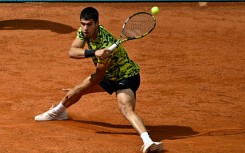 Stretched: Carlos Alcaraz returns the ball to Emil Ruusuvuori 