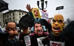 Demonstrators with a puppet of Italy's Prime Minister Giorgia Meloni, centre, at a May Day rally in Turin