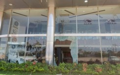 Broken glass of a car showroom in southern Khartoum after a looting attempt while fighting continues in the Sudanese capital
