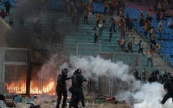 Esperance supporters and riot police clash during a CAF Champions League quarter-final against JS Kabylie near Tunis on April 29.  