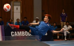 Thailand's Suphawadi Wongkhamchan in doubles action against one of two Cambodian sides in Phnom Penh
