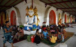 People shelter at a monastery in Sittwe town in Myanmar's Rakhine state on Friday