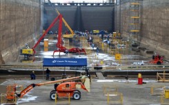 Workers perform maintenance in one of the chambers of the Pedro Miguel locks of the Panama Canal, not far from Panama City, on May 12, 2023 