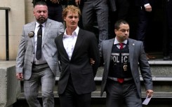 US Marine veteran Daniel Penny (C) is walked out of the New York Police Department 5th Precinct in Lower Manhattan, May 12, 2023, on his way to an arraignment for charges in the chokehold death of Jordan Neely